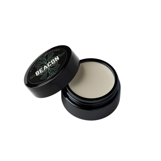 Beacon water based natural hair styling clay in open jar black label showing clay