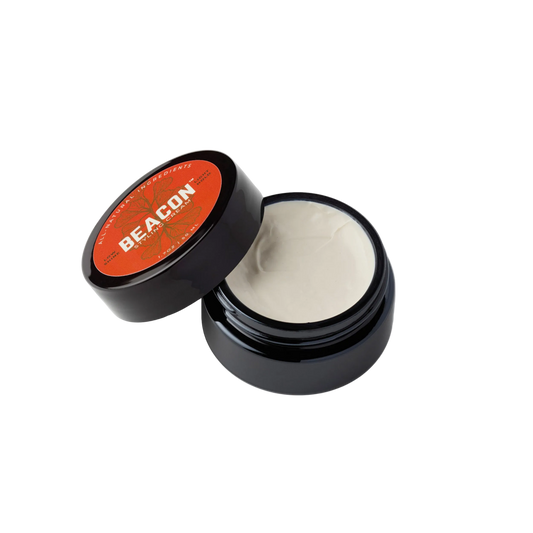 Beacon water based natural hair styling cream in open jar orange label showing cream